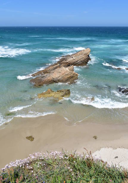 istock Summer landscape with beach with rocks, waves and blue sky. View from a cliff. Viveiro, Lugo, Galicia, Spain. 1220526204