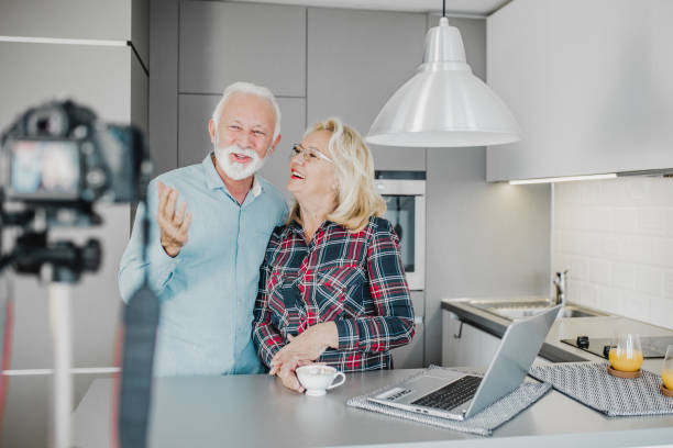 istock Senior couple vlogging at home 1220526563