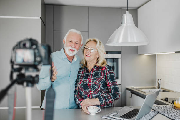 istock Senior couple vlogging at home 1220526595