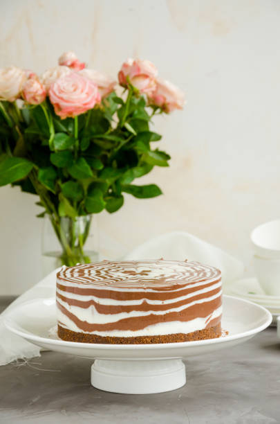 istock No baked zebra marble cheesecake with vanilla and chocolate layers on a white plate on a concrete background. Vertical orientation. Copy space. 1220527699