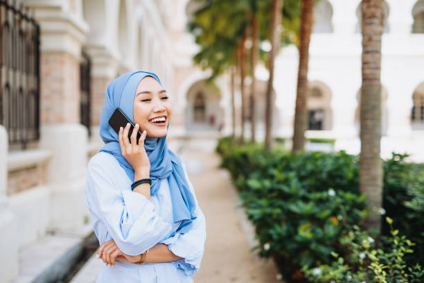 istock Modern muslim woman with hijab using smart phone 1220529759