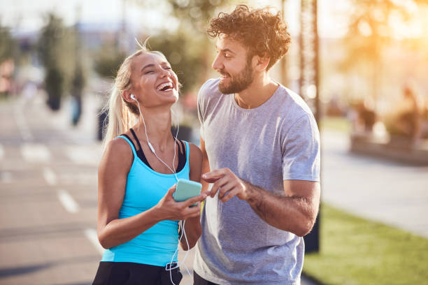 istock Modern couple making pause on the sidewalk during jogging / exercise. 1220531060