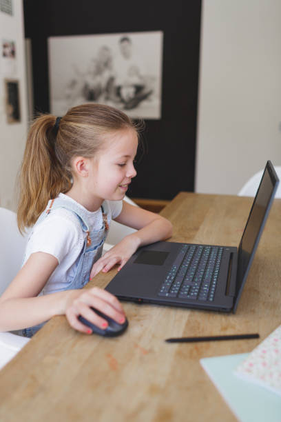 istock girl working on her laptop during home schooling 1220531462