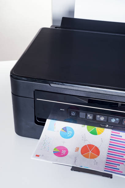 istock Printer and paper isolated on a white home table 1220531956