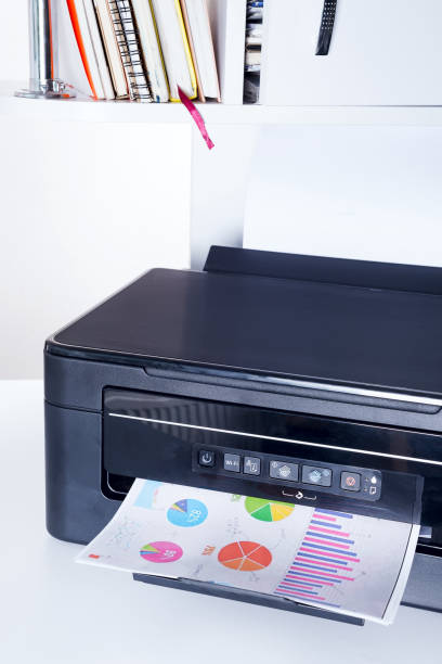 istock Printer and paper isolated on a white home table 1220532786