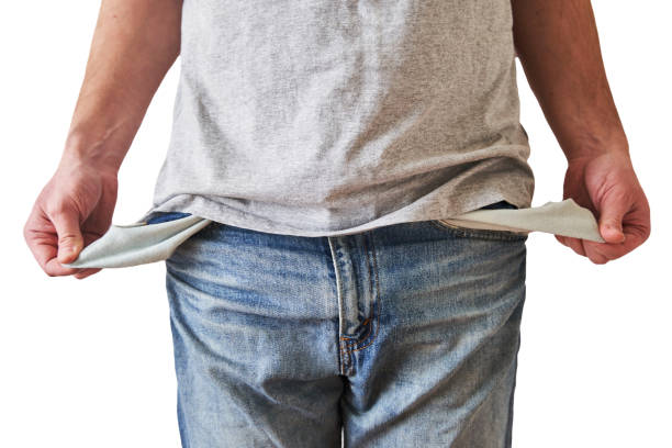 istock Inverted empty pockets. The young man turned out empty jeans pockets 1220532987