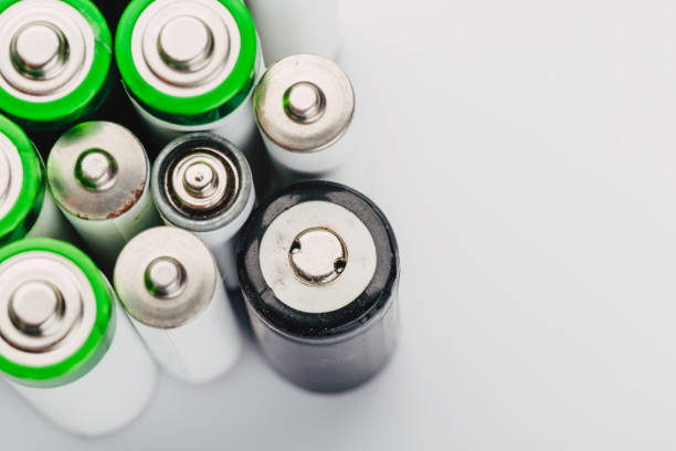 istock many new and used alkaline batteries type AA on a light background. 1220533168