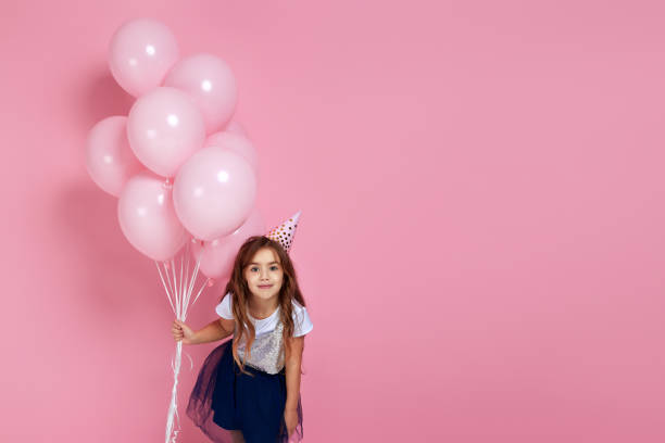 istock child gir with pastel pink air balloons 1220533838
