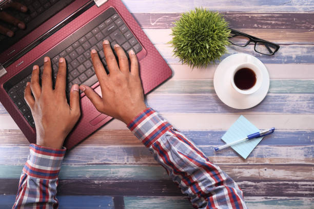 istock high angle view of young man typing on laptop 1220535068