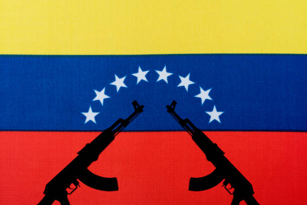 istock Several automatic rifles raised up on the background of the Venezuelan flag 1220536025