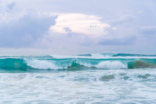 istock Sunset over ocean - turquoise stormy waves against cloudy sky  background. 1220536509