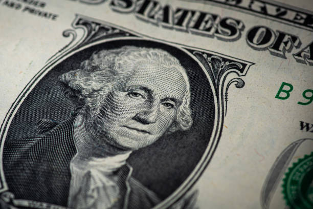 istock one dollar bill with a lit face on a wooden background 1220536986