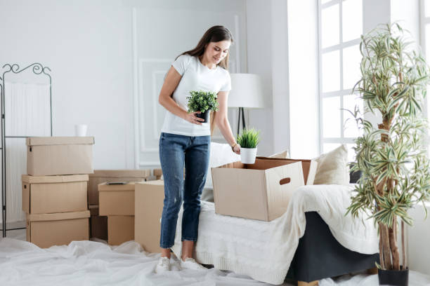 istock young woman taking personal items out of a cardboard box 1220537906