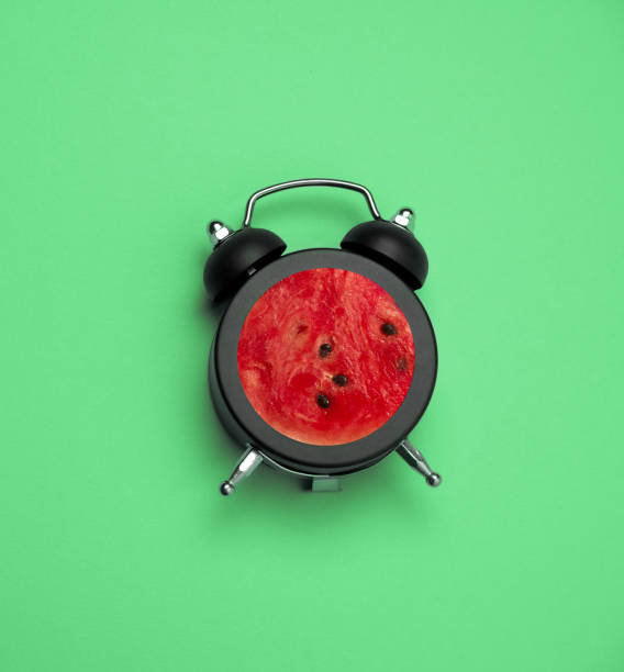 istock bright summer square poster vintage  black alarm clock with watermelon inside 1220539828