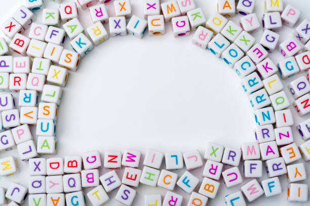 istock Many colorful decorative cubes with letters on a white background. 1220540490