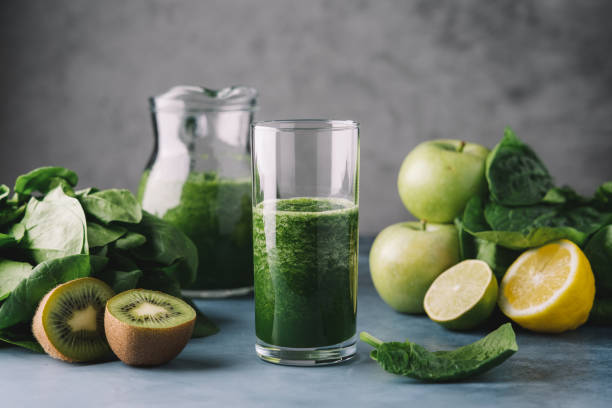 Green smoothie in  glass. Spinach, apple, kiwi, lemon, lime ingredients