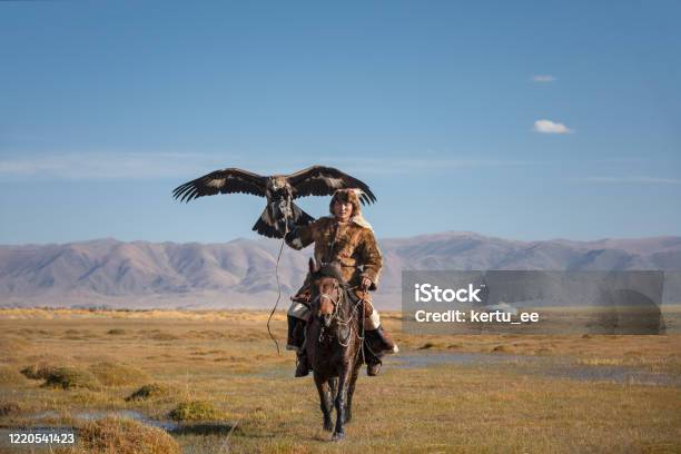 A Young Eagle Hunter With His Eagle And Horse Stock Photo - Download Image Now - Kazakhstan, Eagle - Bird, Horse