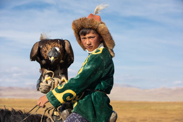 istock Kazakh eagle hunter with his golden eagle and horse. 1220541430