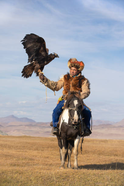 istock A traditional kazakh eagle hunter with his horse and golden eagle. 1220541431