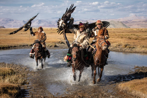 istock A group of eagle hunters holding their golden eagles on horseback. 1220541492