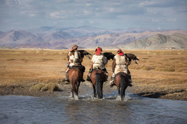 istock A group of eagle hunters holding their golden eagles on horseback. 1220541498