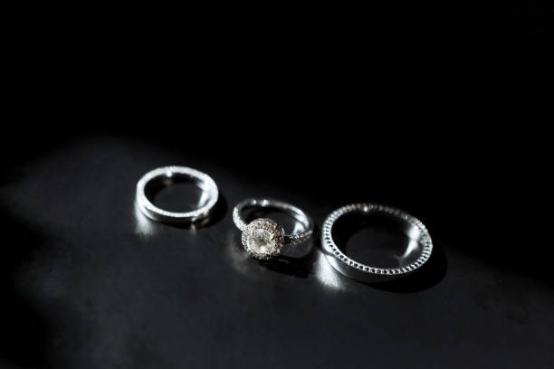 istock 3 wedding gold rings on the black background. Wedding. 1220543660