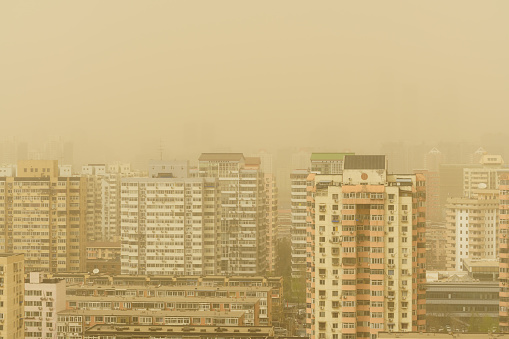 Dust weather in modern city of Beijing, China. Environmental threats.