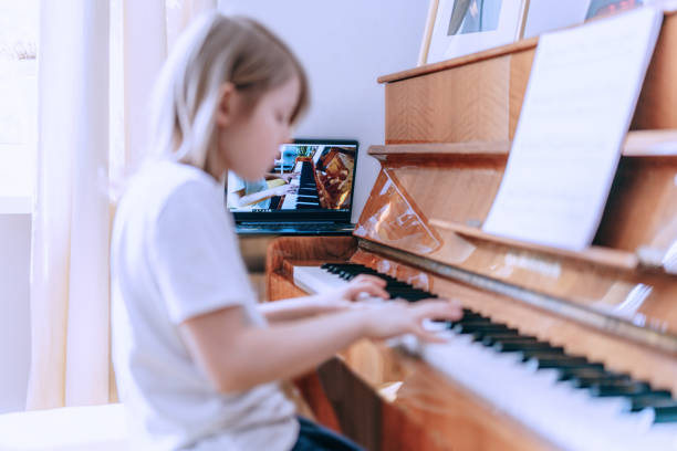 istock Young boy having online piano class. Home education. Close-up 1220545246