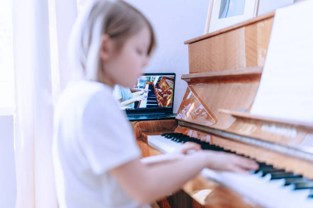 istock Young boy having online piano class. Home education. Close-up 1220545249
