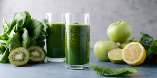 istock Green smoothie in  glass. Spinach, apple, kiwi, lemon, lime ingredients 1220545327