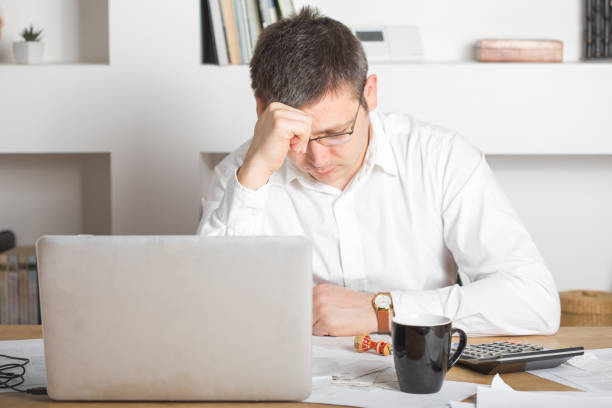 istock Businessman having stress with laptop computer working in the office, caucasian man touching his head, he is having a bad headache, stress and overwork concept. 1220545406
