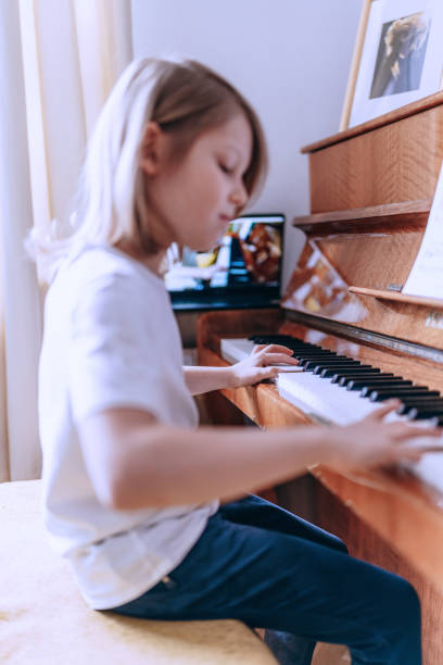 istock Young boy having online piano class. Home education. 1220545750