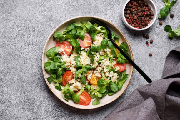 istock Fresh bulgur salad with tomatoes.  Top view, gray background 1220545925
