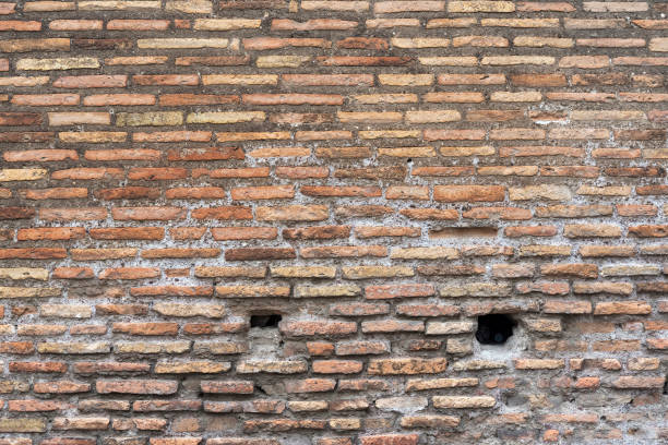 istock Background of old dirty brick wall with peeling plaster. 1220547121