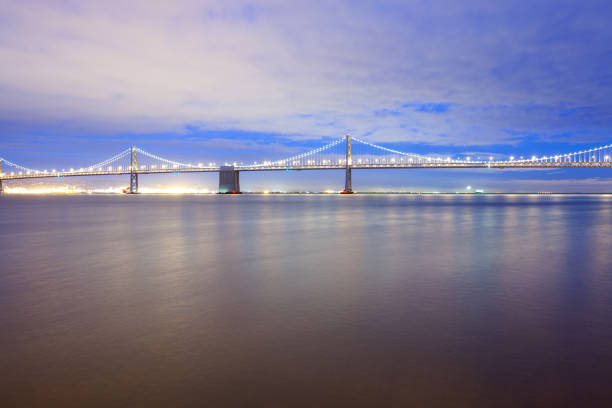 oakland Bay Bridge with rising sun in San Francisco, California, USA