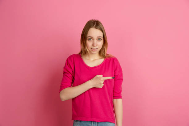 istock Caucasian young woman's monochrome portrait on pink studio background, emotinal and beautiful 1220548674