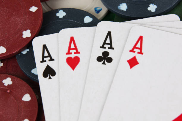 istock Four aces winning hand on a pile of betting chips 1220549069