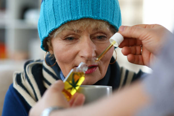 istock Elderly woman taking medicine 1220549264