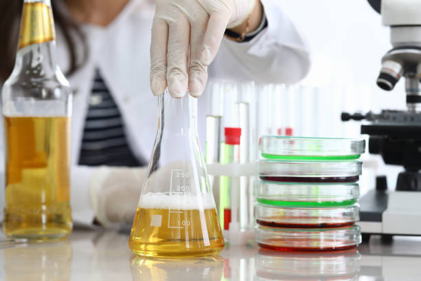 istock Researcher mixing test tube in lab 1220549332