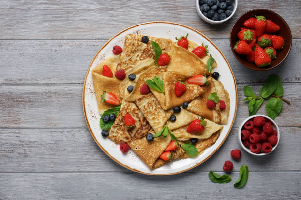 istock Thin crepes decorated with fresh berries and mint leaves 1220550005