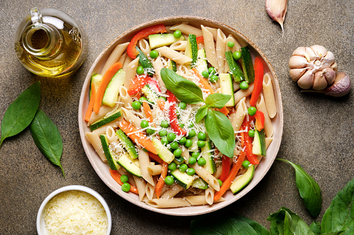 Pasta with zucchini, carrots, red bell pepper, garlic, parmesan and peas. Primavera Traditional Italian Vegetable Pasta