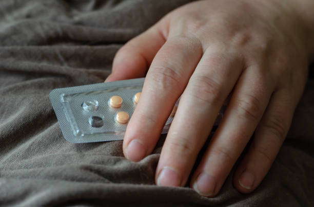 Blister with pills in a female hand.