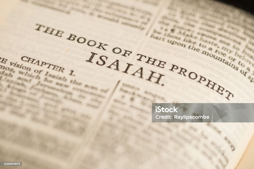 Close up macro image of a page from the bible showing ‘The Book of Isaiah’. Book Stock Photo
