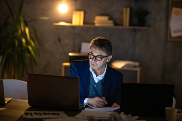 istock Businessman in his office working late at night 1220552976