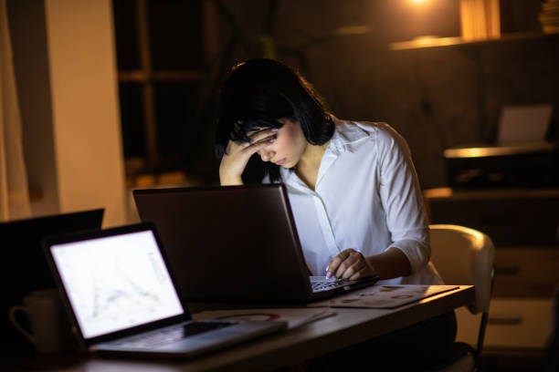 istock Businesswoman working late at night in office 1220552995