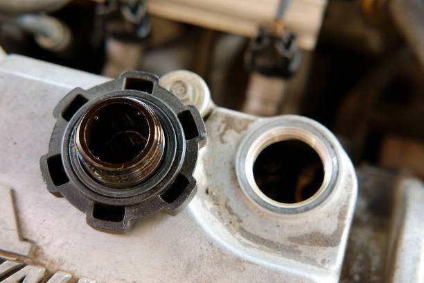 istock hand open oil cap of car engine for maintenance service 1220554434