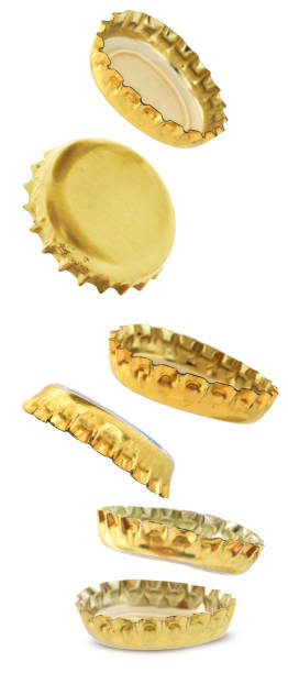 Beer bottle caps are falling isolated on white