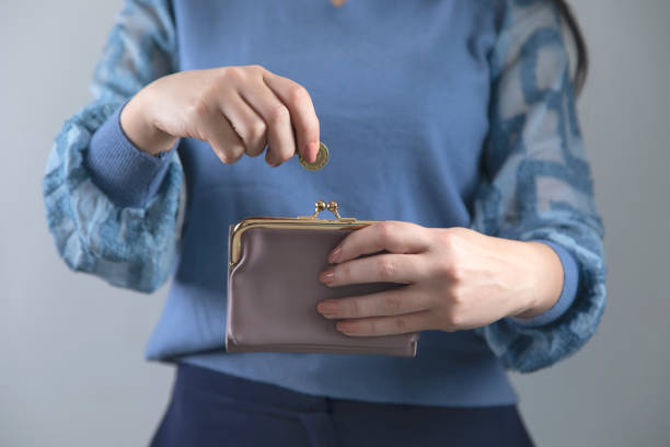 istock woman hand wallet with coins 1220556940