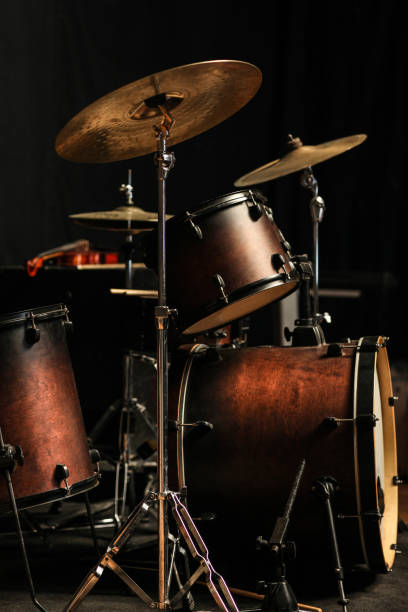 Set of yellow drums isolated on black background.
