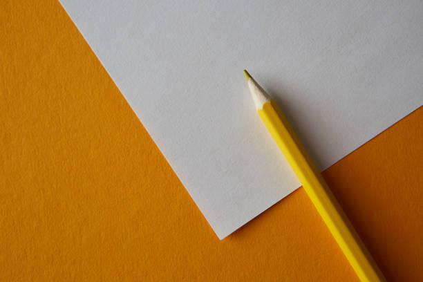 istock Yellow colored pencil lying on a yellow and white background 1220558634